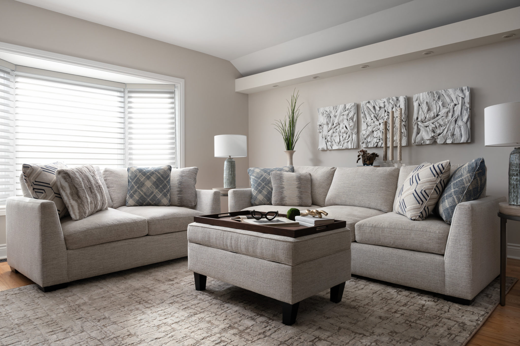 Grey walls, cream and grey upholstered furniture, natural, layered textures.