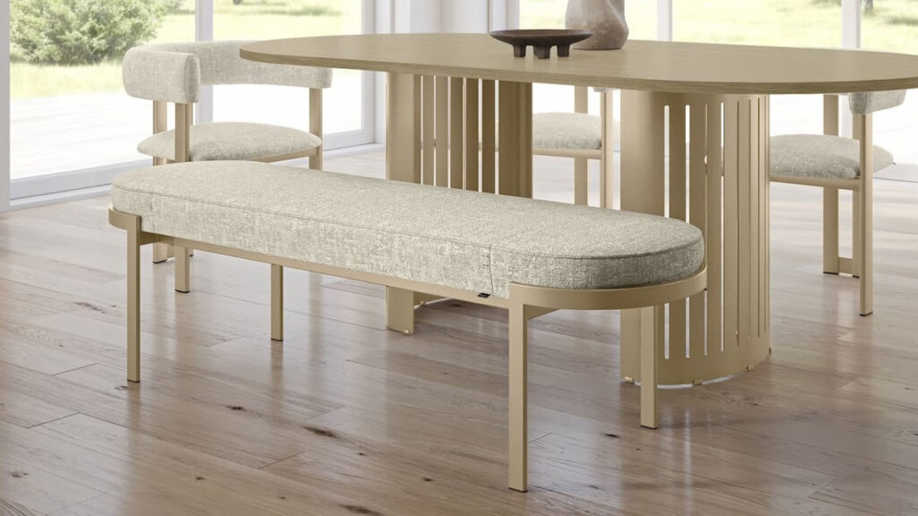 Light wood dining table and bench with textured fabric – natural interior design trend 2026.